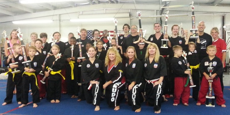 Karate Students and Instructors posing with Trophies